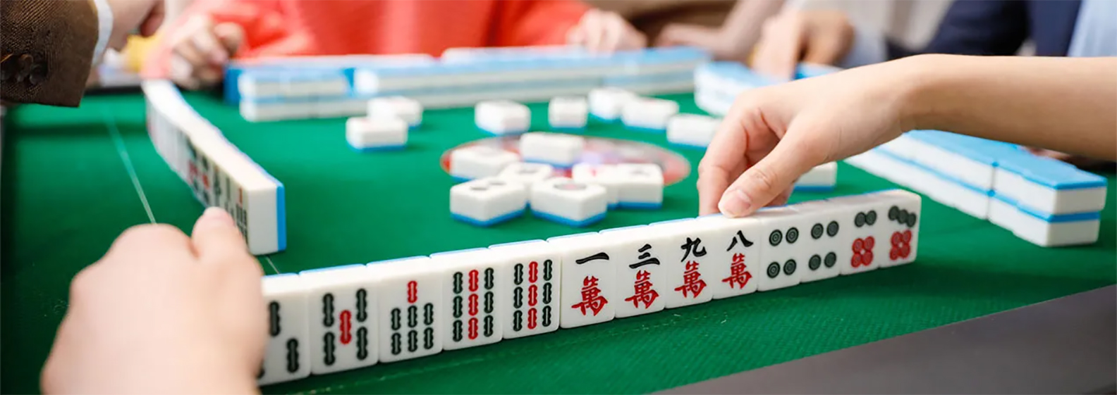 Mahjong tiles set up on a rack during play.