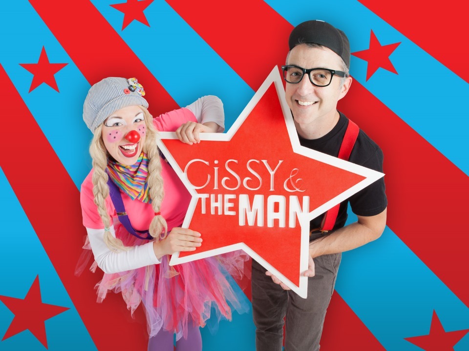 Photograph of Cissy and the Man holding a star with their names on a blue/red striped background.