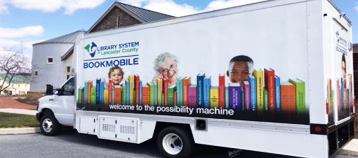 large white box truck with picture of lined up books on the side