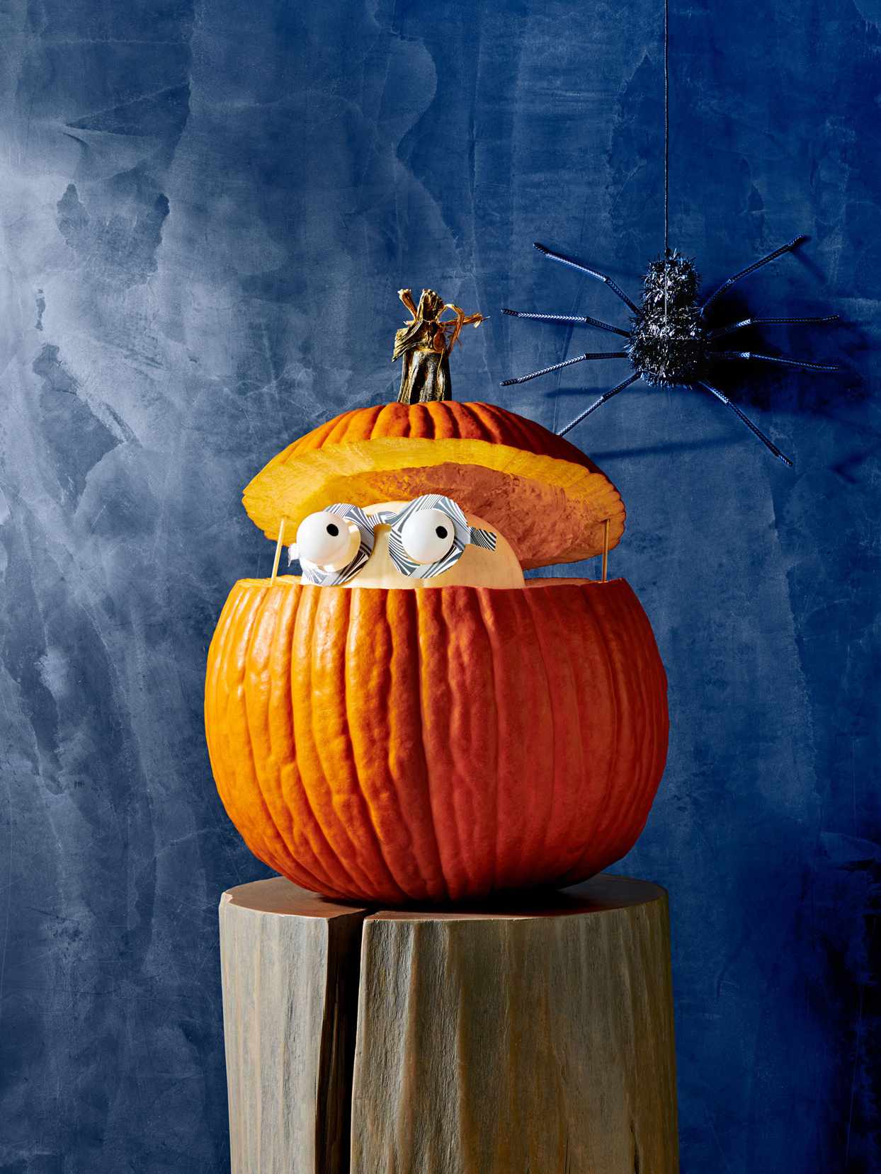 Open pumpkin with figure inside.