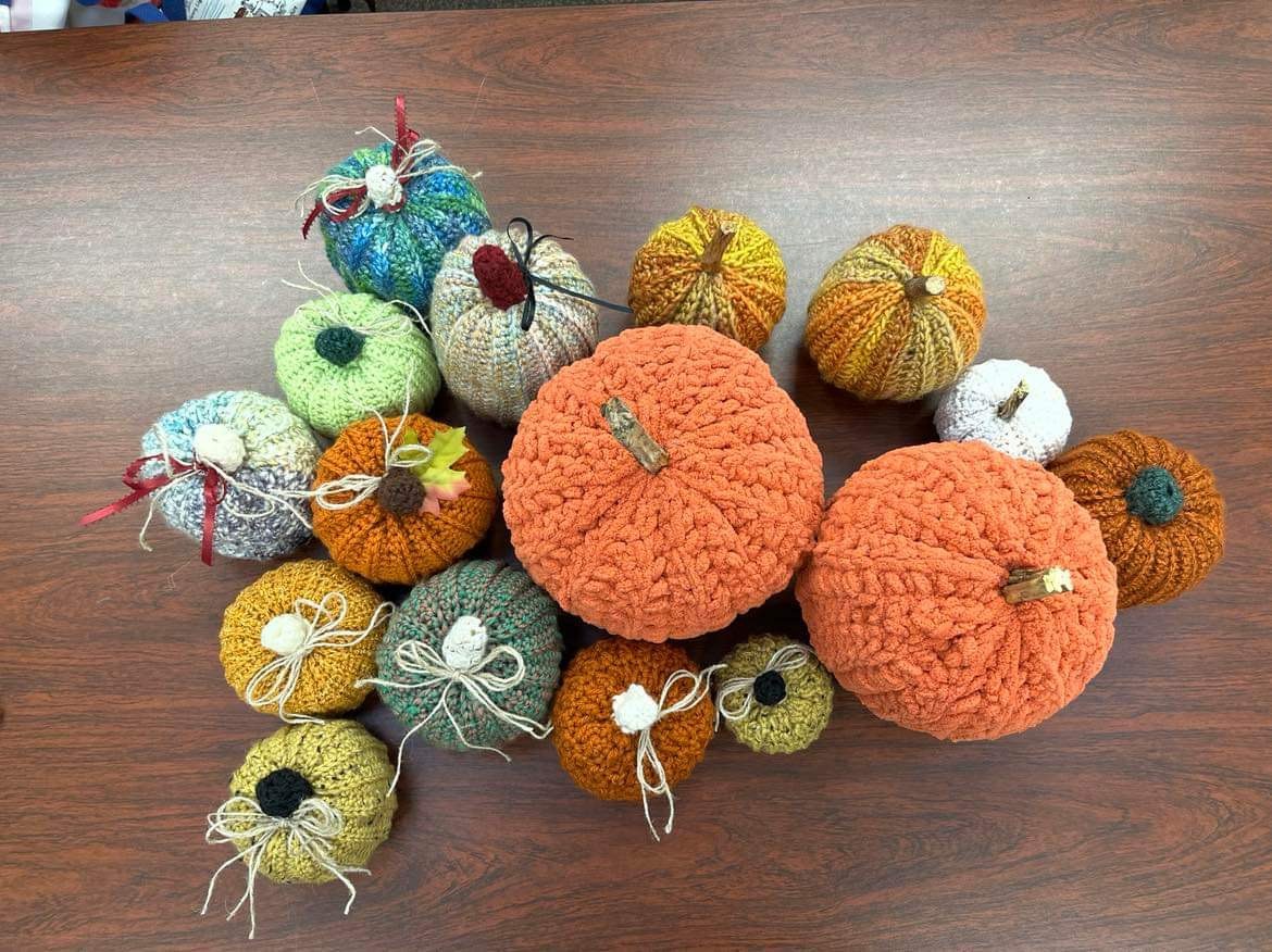 Photo of crocheted pumpkins with multiple different colors. 