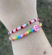 Colorful beaded bracelets on wrist.