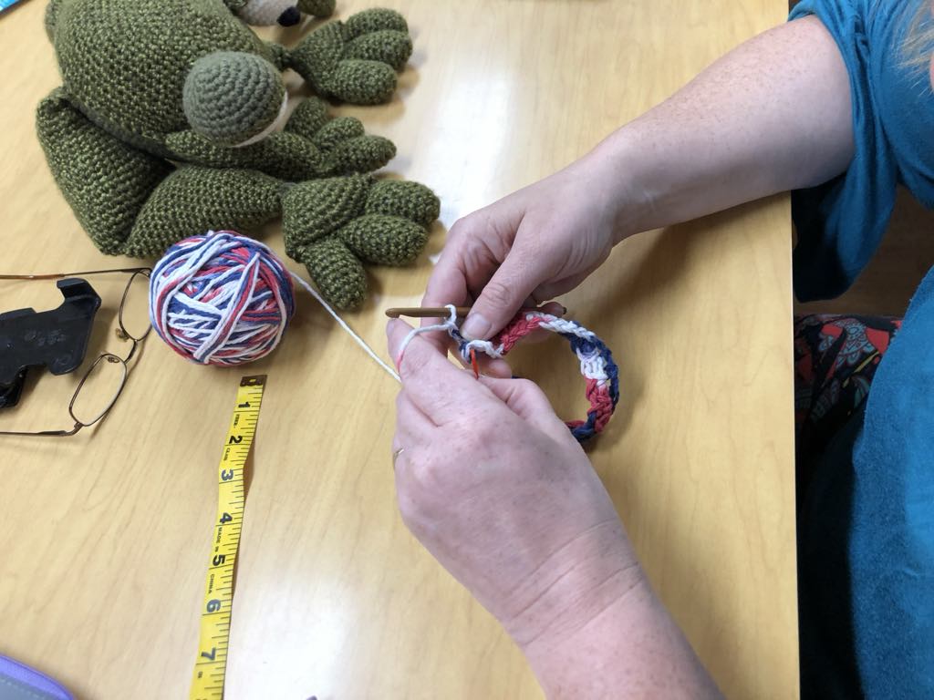 Hands crocheting blanket