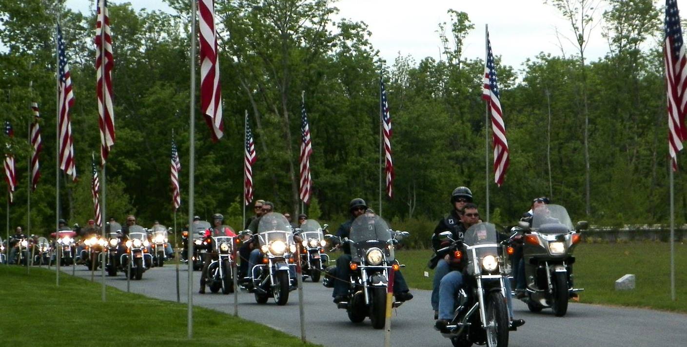 motorcycle riders with American flags on bikes