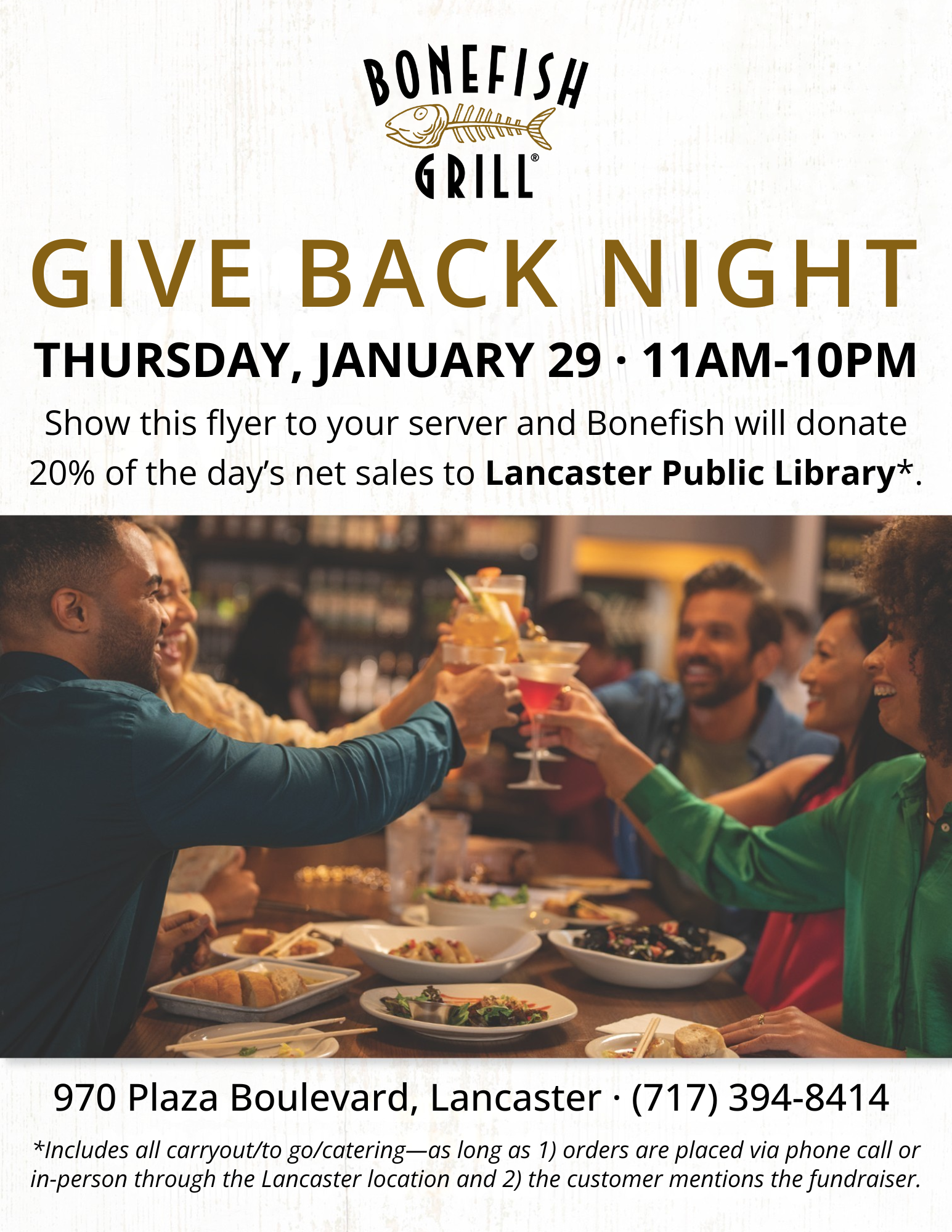 group of people cheers-ing at a dinner table