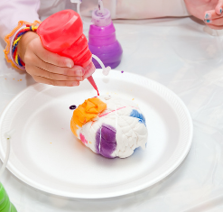 Hand squirting pink die on a t-shirt. 