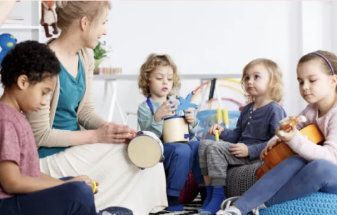 Adult and children with musical instruments
