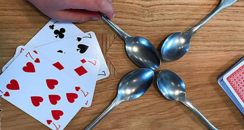 Cards and spoons on table.