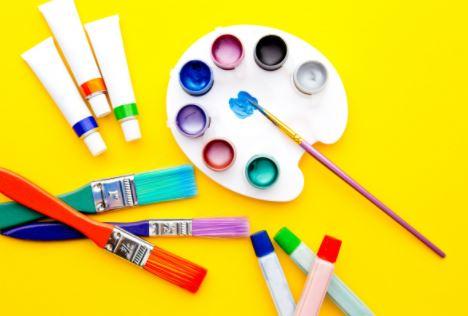 Art supplies on yellow background.