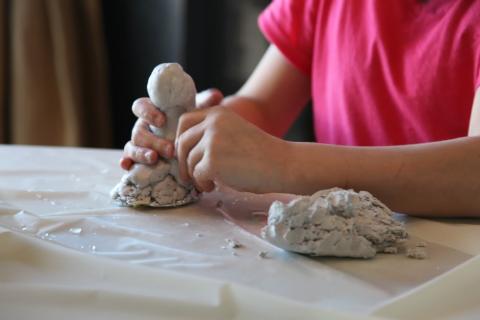 Child molding clay.