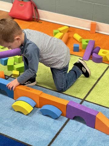 Child playing with foam blocks 