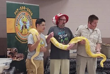 Jessie and friends holding a big snake.