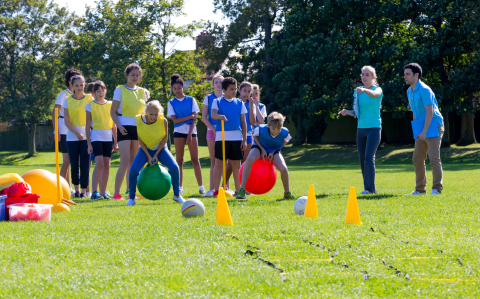 Teens outside playing.