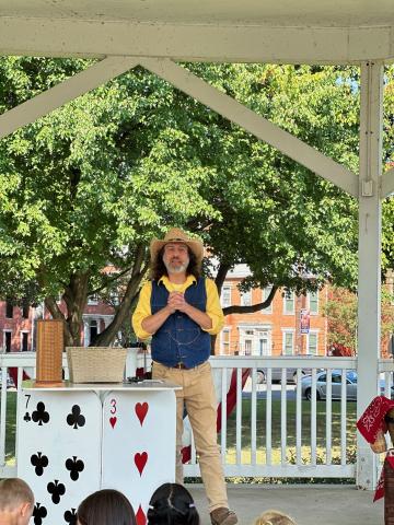 Erick Hershey - magician performer in tan pants and gray vest 