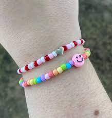 Colorful beaded bracelets on wrist.