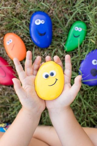 painted rocks in child's hand