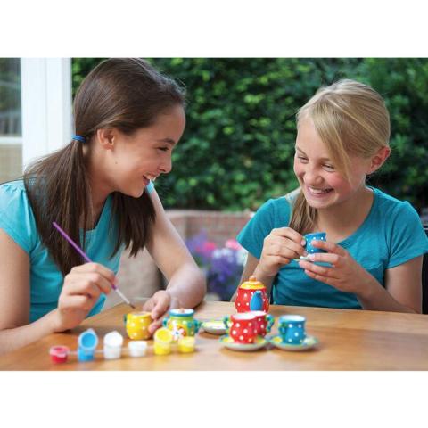 Girls painting tea cups.