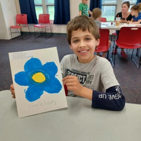 boy with flower art he made