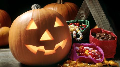 Happy jack-o-lantern and candy.