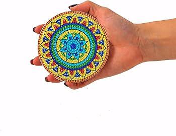 Hand holding a diamond painting coaster.