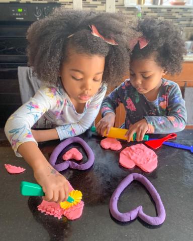 Girls creating with play dough.