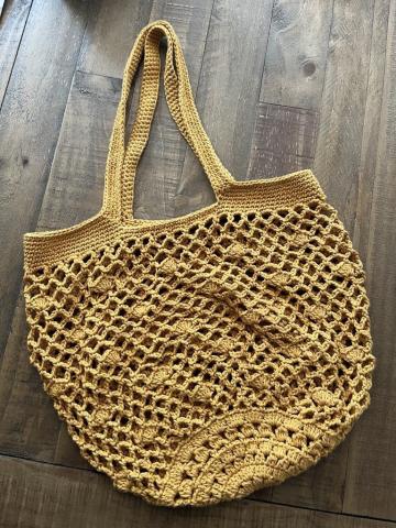 photo of a yellow crocheted boho bag