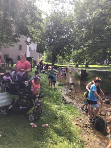 image of people by the stream at the last year's event