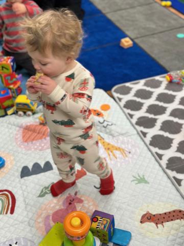 Child wearing pajamas playing at story time