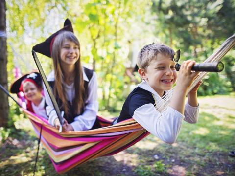 Kids in a hammock pretending to be pirates.