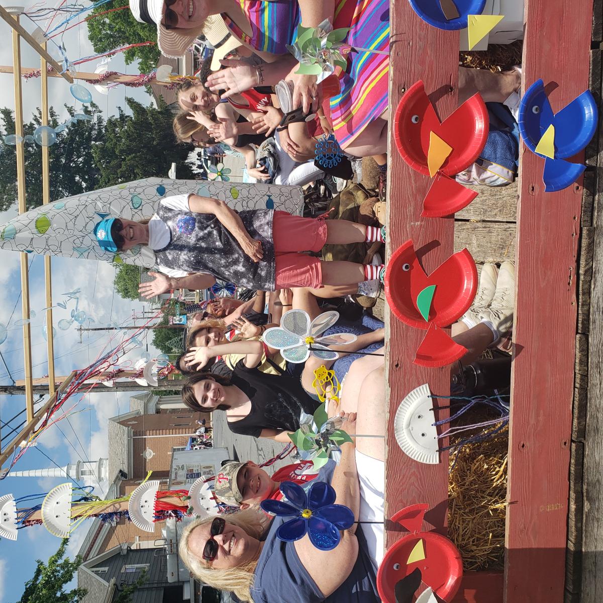 People waving at the camera and sitting on a parade float