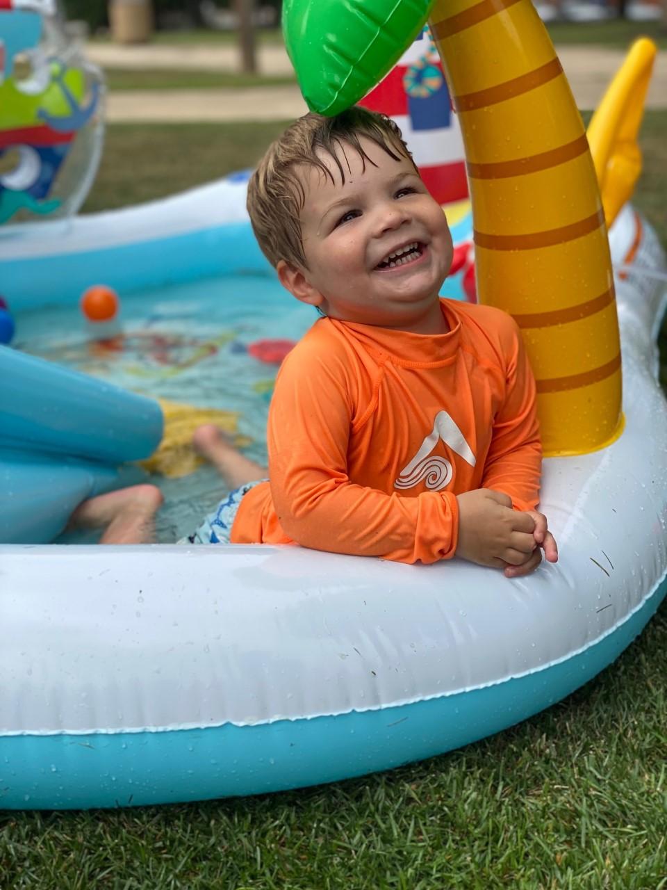 Child playing in pool during water time. 