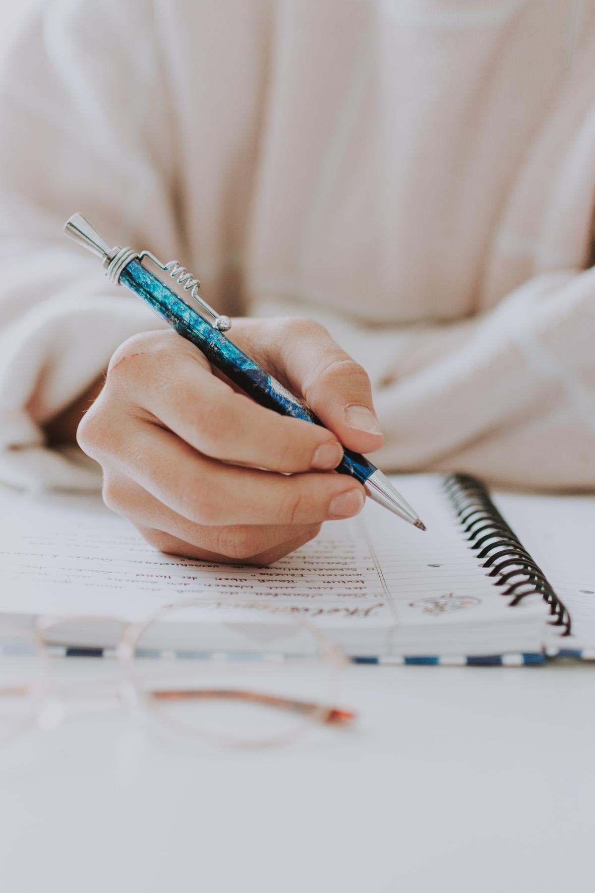 person writing in a notebook