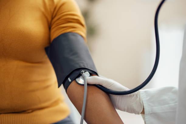 Woman getting blood pressure and heart rate taken.