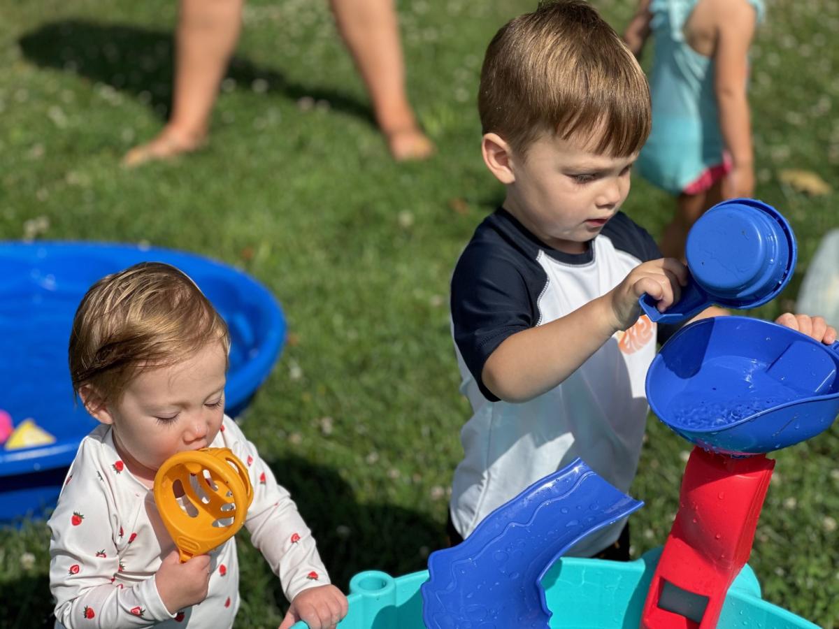 Children playing in water table during water play. 