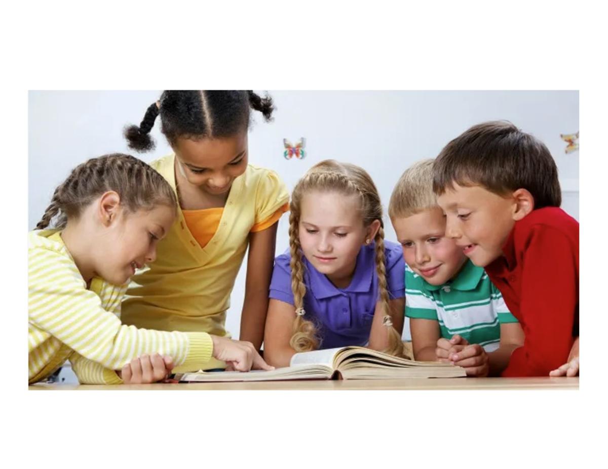 Children gathered around a book at a table.