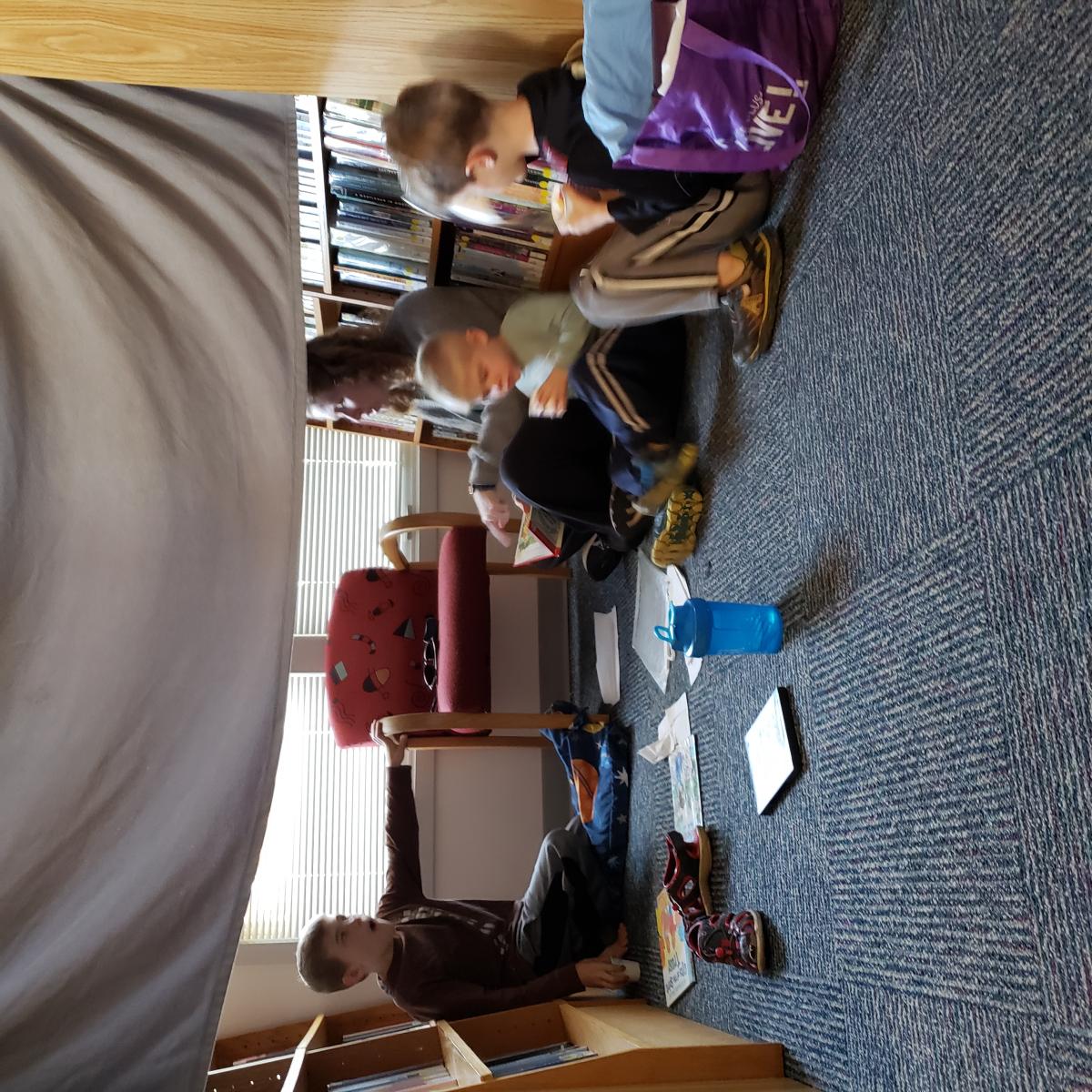 family reading in blanket fort