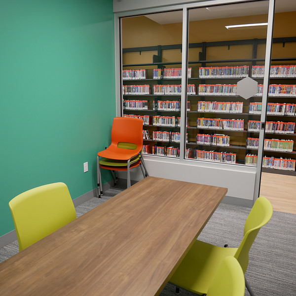 Small room with carpeting and a green wall