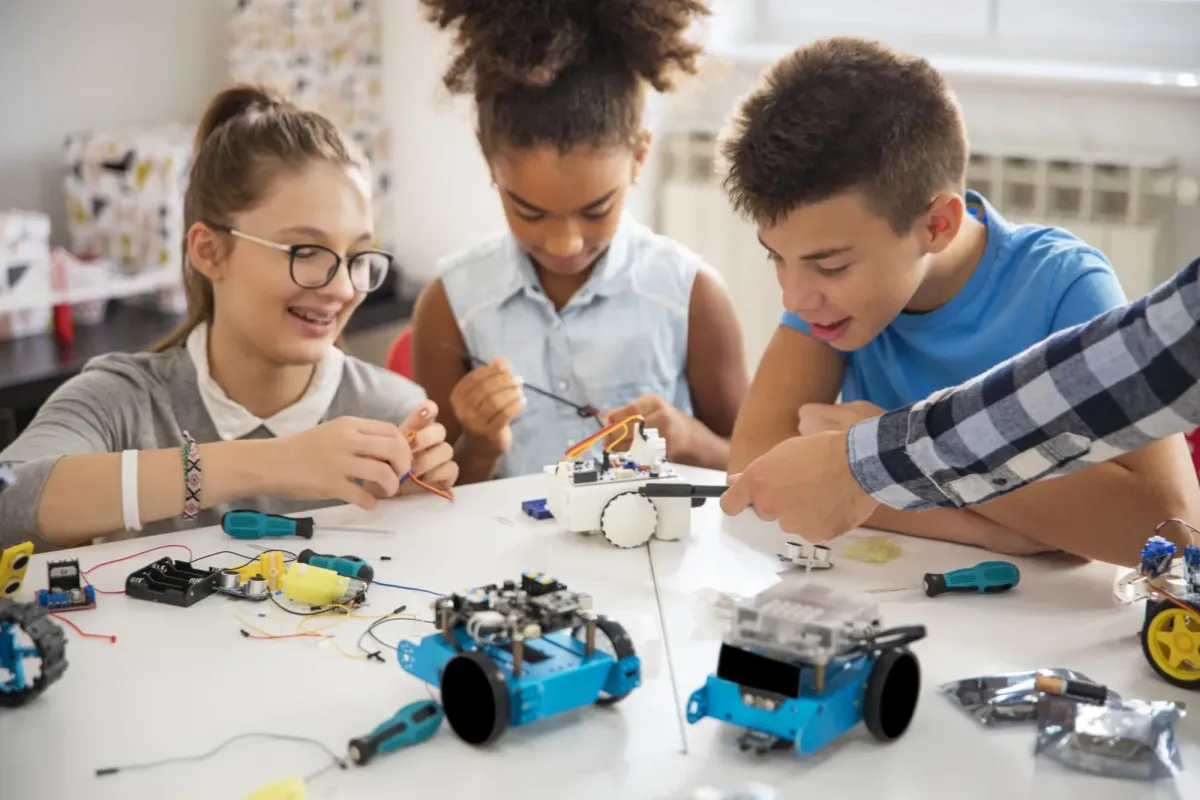 Tweens building robots.