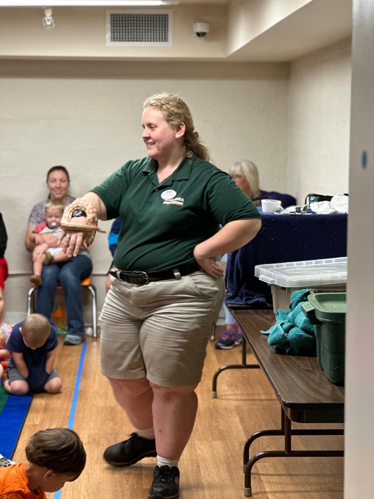 Zookeeper holding an animal from Zoo