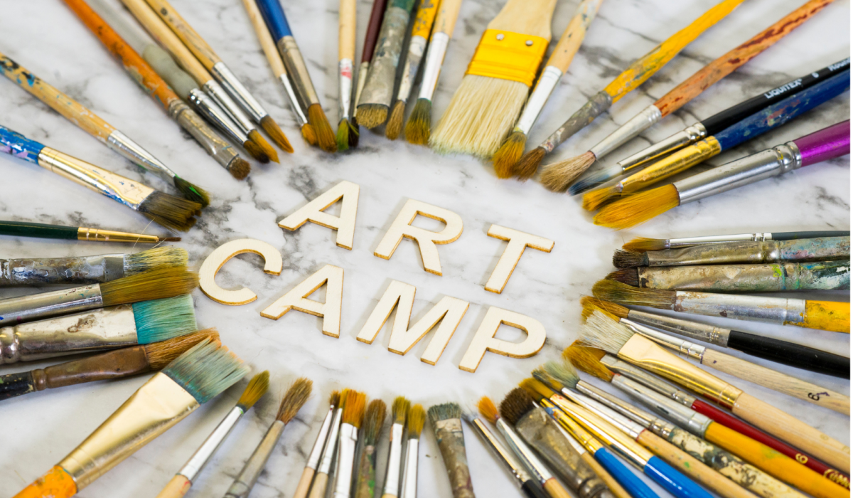 "Art Camp" surrounded by pencils & brushes.