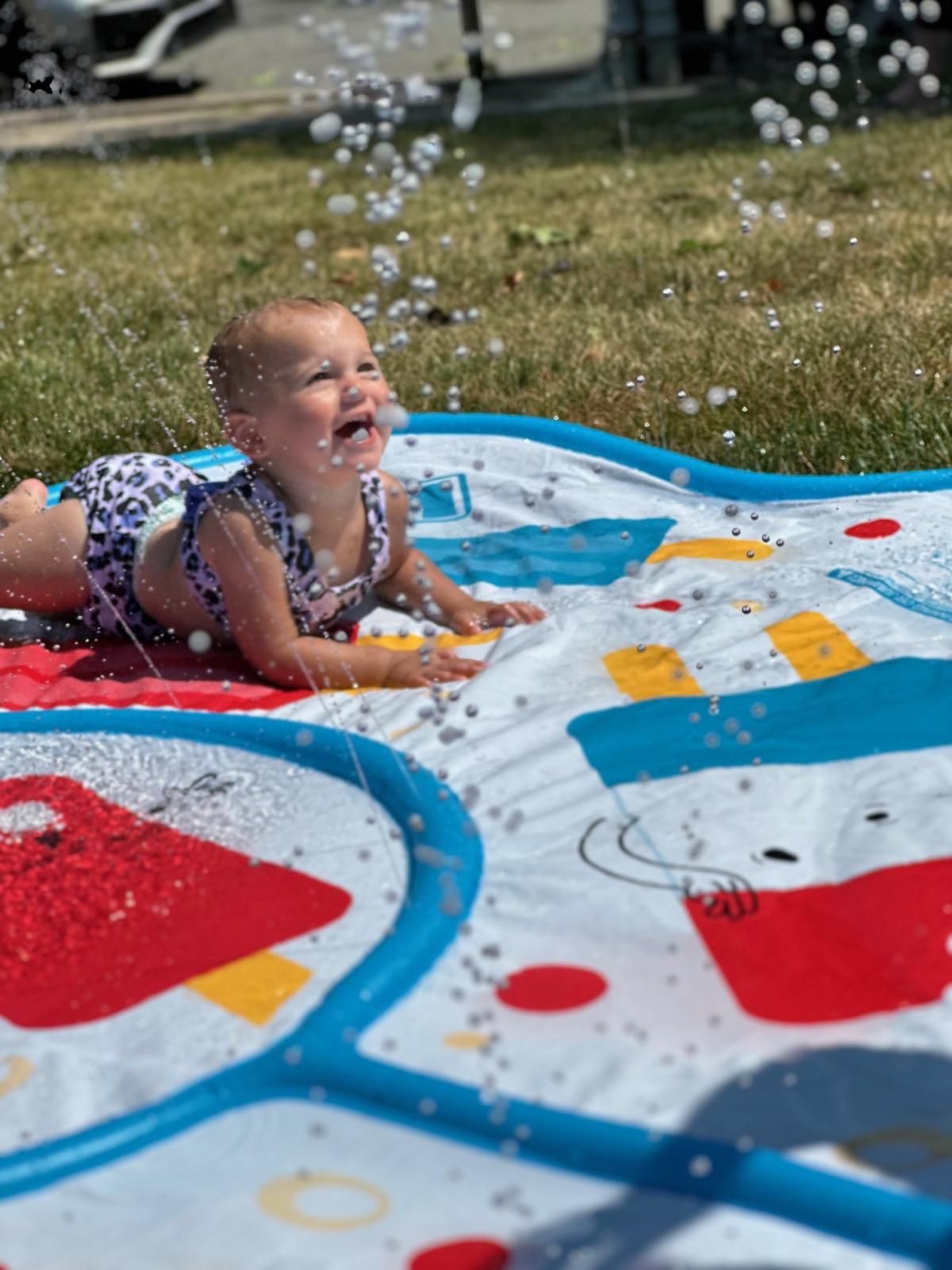 Child playing in splash pad during water play