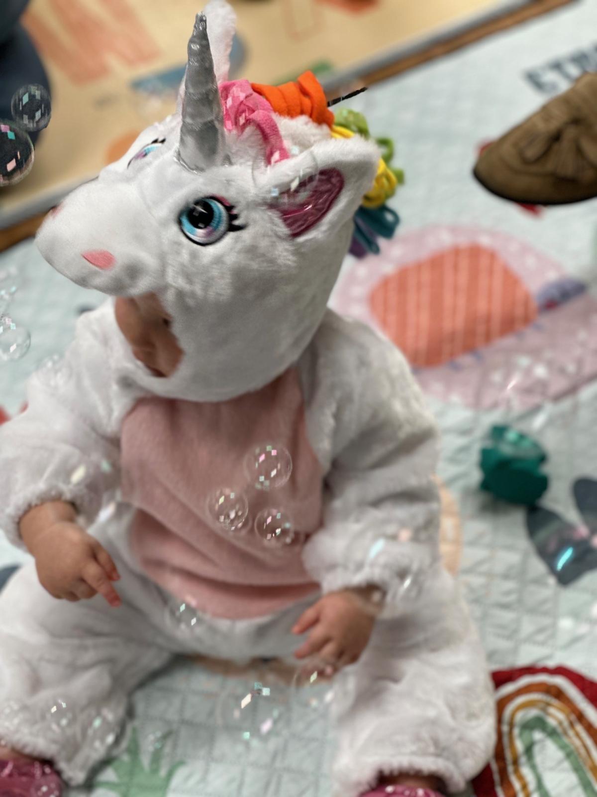 Child in unicorn halloween costume 