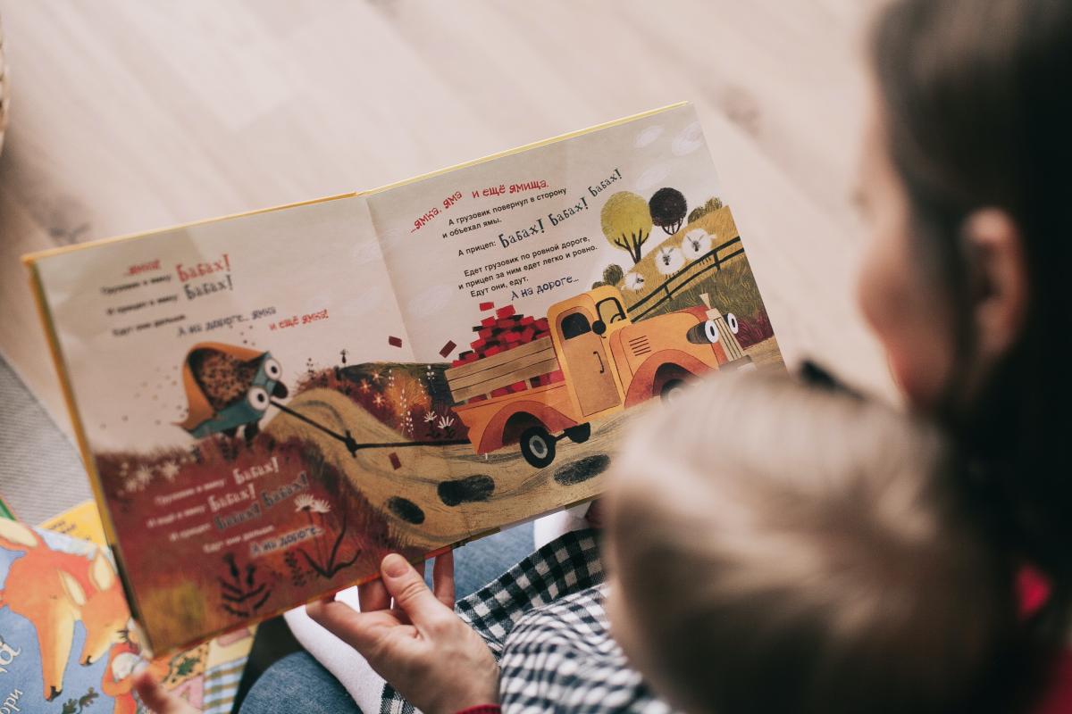 Parent reading book to child.