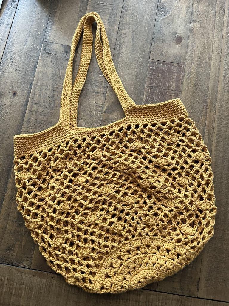 photo of a yellow crocheted boho bag