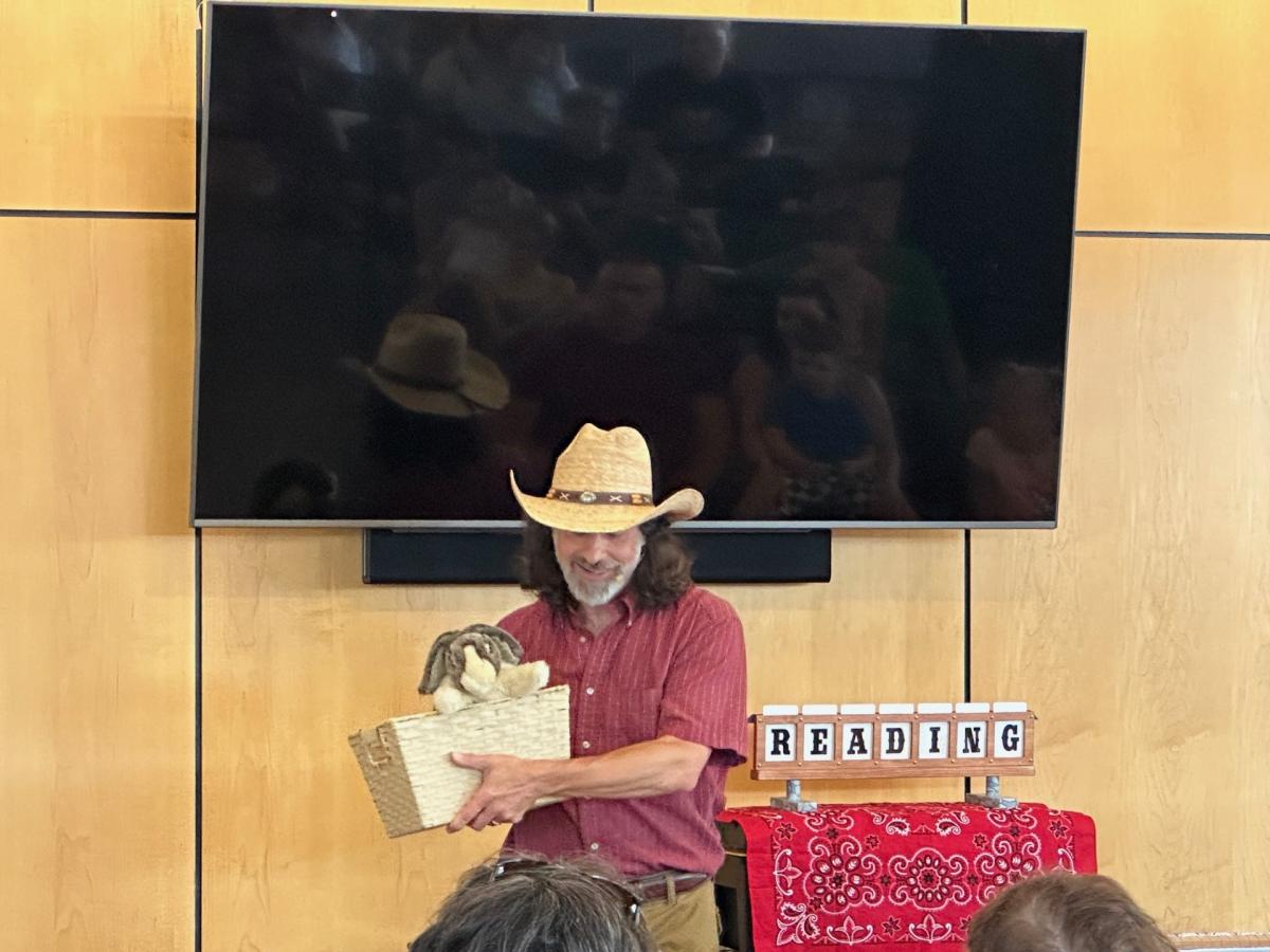 Erick Hershey - magician performer in red shirt wearing tan hat