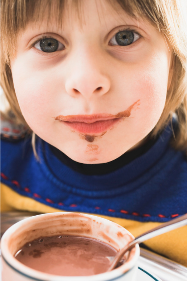 Child drinking hot chocolate.